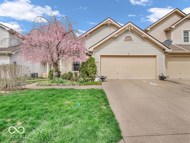 6556 Aintree Ter, Indianapolis, IN 46250 - view of front of property with a front lawn, concrete driveway, central air condition unit, and an attached garage