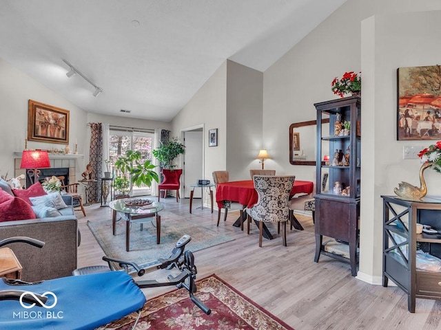 6556 Aintree Ter, Indianapolis, IN 46250 - living room with track lighting, vaulted ceiling, wood finished floors, and visible vents