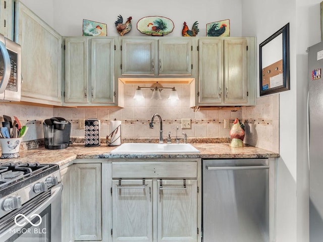 6556 Aintree Ter, Indianapolis, IN 46250 - kitchen featuring backsplash, a sink, appliances with stainless steel finishes, and light countertops
