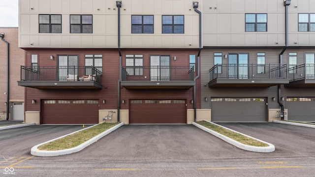 view of building exterior featuring aphalt driveway and a garage