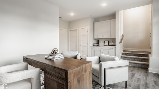 office space with recessed lighting, visible vents, light wood finished floors, and baseboards