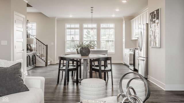 dining room featuring stairs, dark wood-type flooring, and baseboards