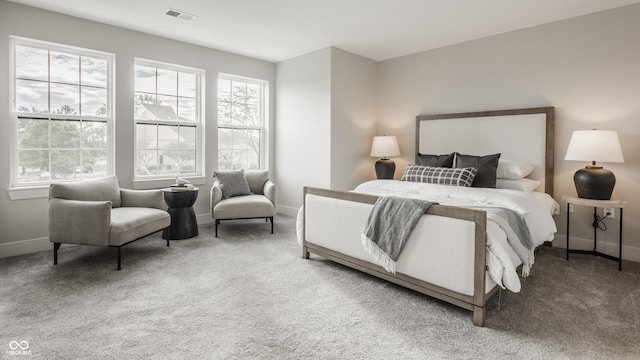 carpeted bedroom featuring visible vents and baseboards