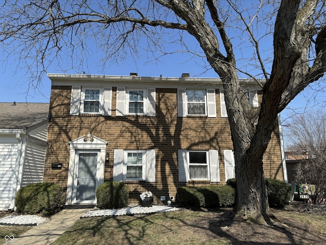 colonial house featuring brick siding