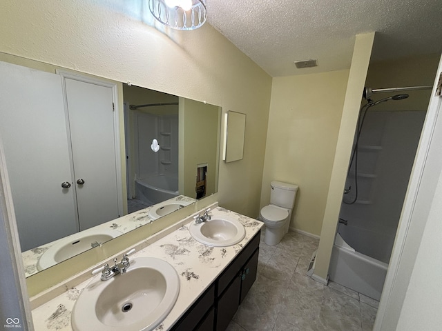 full bath with a textured ceiling, double vanity, shower / bath combination, and a sink