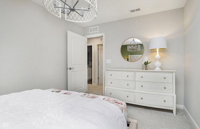 bedroom featuring visible vents, light carpet, and a notable chandelier