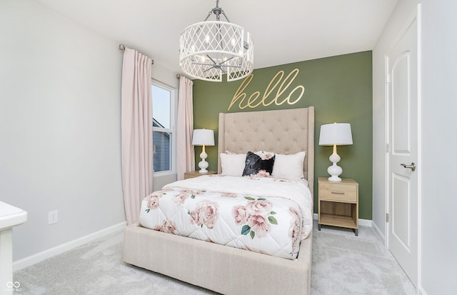 bedroom featuring a chandelier, baseboards, and carpet floors