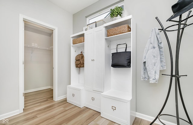 mudroom with light wood finished floors and baseboards