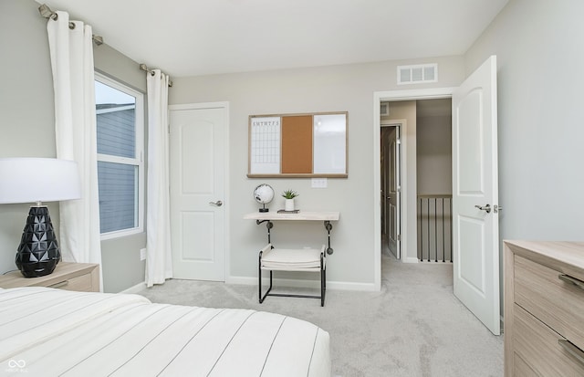 bedroom with baseboards, visible vents, and light carpet