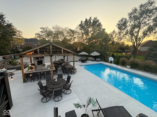 view of swimming pool with outdoor dry bar, a fenced in pool, a gazebo, outdoor dining area, and a patio area