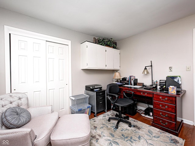 office space with baseboards and wood finished floors