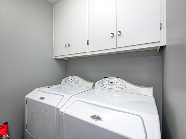 laundry area with washer and dryer and cabinet space