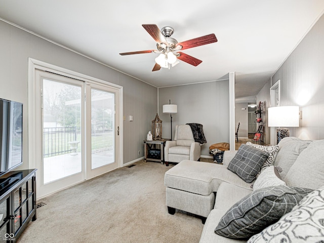 living area featuring visible vents, carpet floors, and ceiling fan