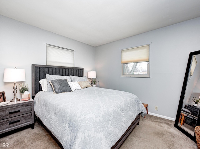 bedroom with baseboards and carpet