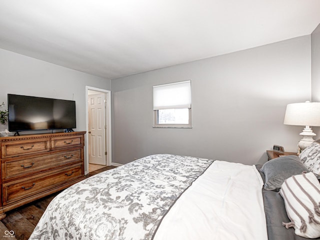 bedroom with dark wood-type flooring