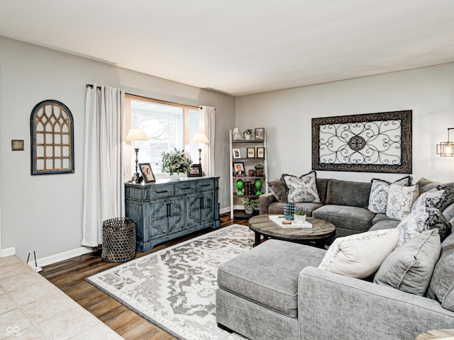 living room featuring baseboards and wood finished floors