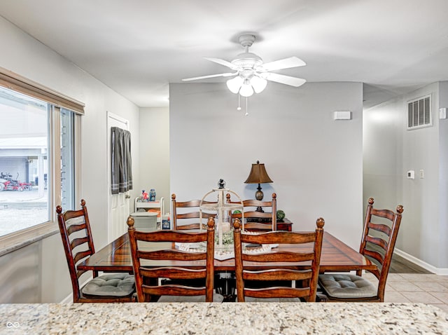 dining space featuring a wealth of natural light, visible vents, a ceiling fan, and light tile patterned floors