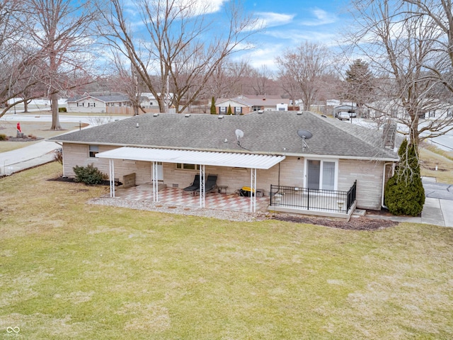 rear view of house with a shingled roof, a residential view, a chimney, a yard, and a patio