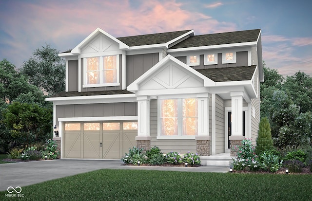 view of front of house featuring concrete driveway, roof with shingles, a lawn, a garage, and stone siding