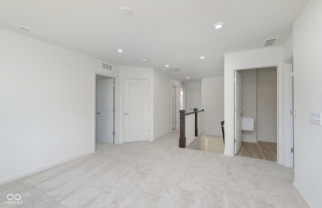 unfurnished bedroom featuring recessed lighting, visible vents, and carpet flooring