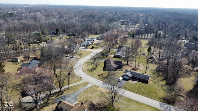 birds eye view of property with a wooded view