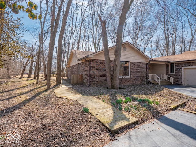 view of home's exterior with a garage and brick siding