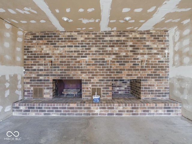 room details featuring a fireplace and concrete flooring