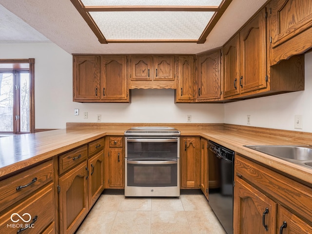 kitchen with double oven range, black dishwasher, and brown cabinetry