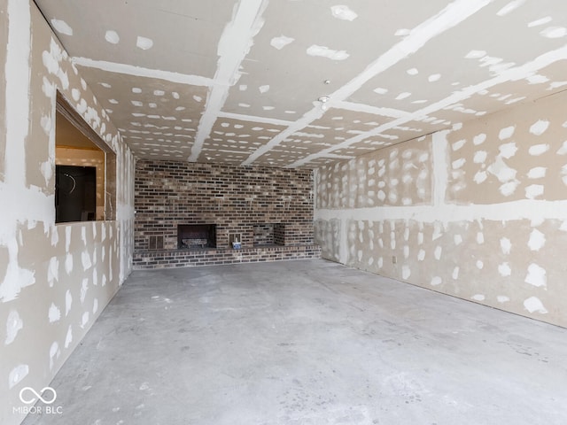 unfurnished living room featuring a fireplace and concrete flooring