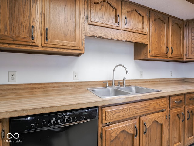 kitchen featuring brown cabinetry, butcher block countertops, black dishwasher, and a sink