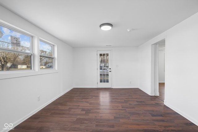 unfurnished room featuring wood finished floors and baseboards