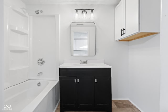 full bathroom featuring baseboards, bathing tub / shower combination, and vanity