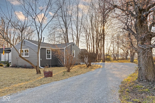 property exterior at dusk with a yard