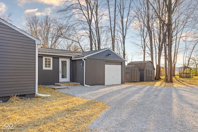 exterior space with driveway and a shed