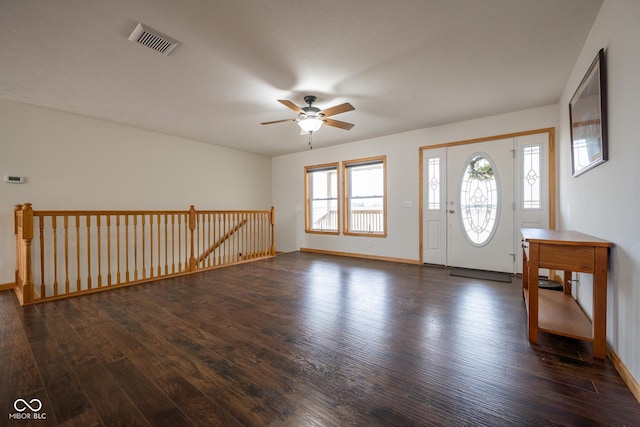 foyer with dark wood finished floors, a ceiling fan, visible vents, and baseboards