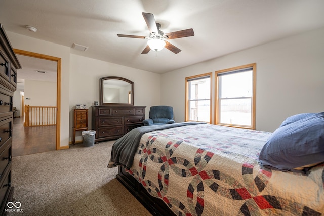 carpeted bedroom featuring visible vents and ceiling fan