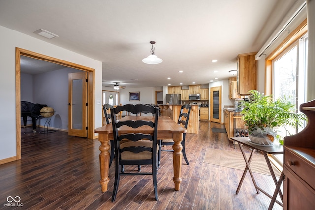 dining room with dark wood-style floors, visible vents, recessed lighting, and baseboards