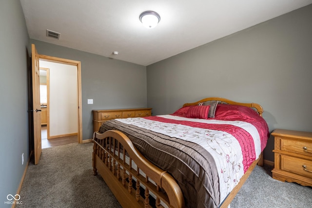 bedroom with carpet, visible vents, and baseboards