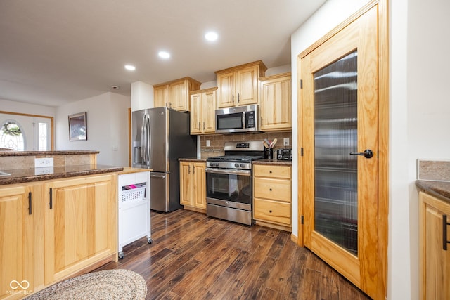 kitchen with light brown cabinets, dark wood finished floors, recessed lighting, appliances with stainless steel finishes, and backsplash