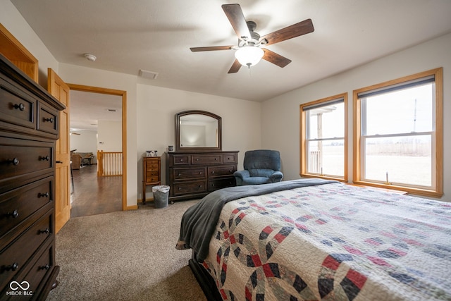 bedroom with a ceiling fan, carpet, visible vents, and baseboards