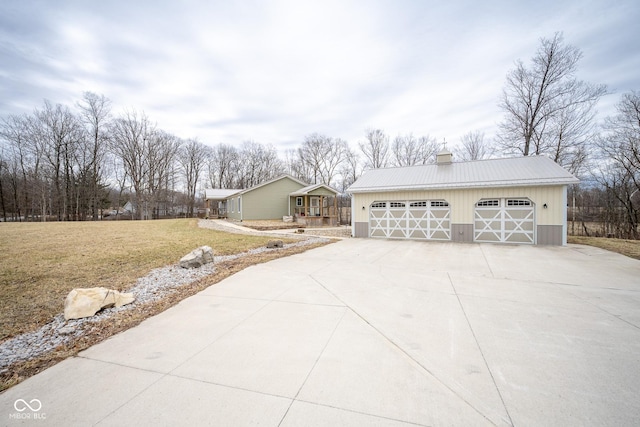 exterior space featuring a yard, a garage, and an outdoor structure