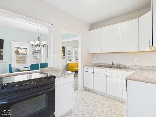 kitchen with a sink, light countertops, black range with electric stovetop, white cabinetry, and a notable chandelier