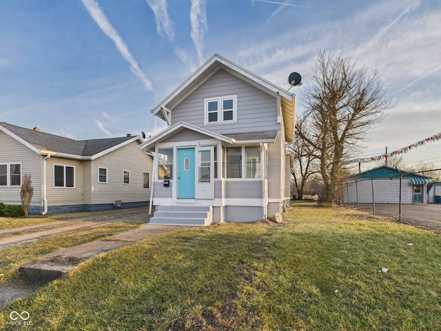 bungalow-style house featuring a front lawn and entry steps