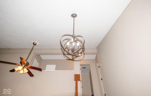 interior details with ceiling fan with notable chandelier