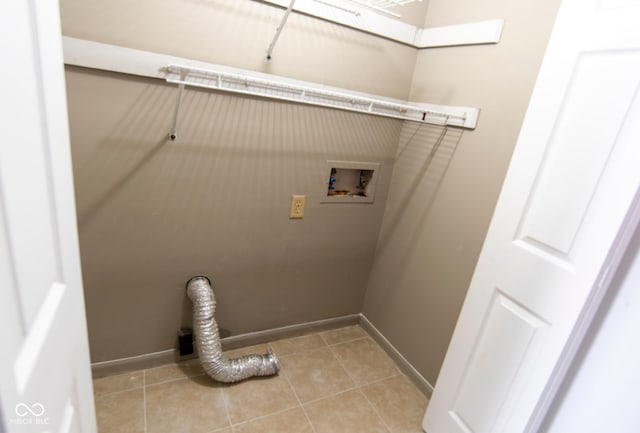 laundry area featuring light tile patterned floors, laundry area, baseboards, and washer hookup