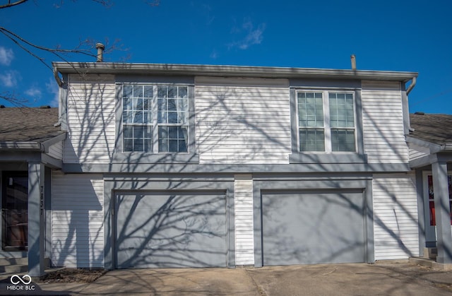 view of front of house featuring concrete driveway and an attached garage