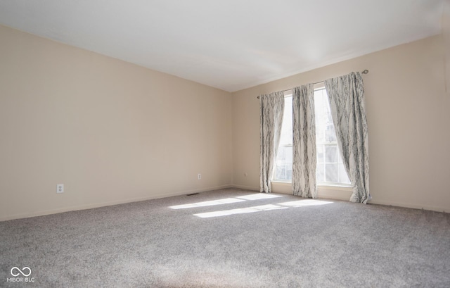 spare room with visible vents and carpet flooring