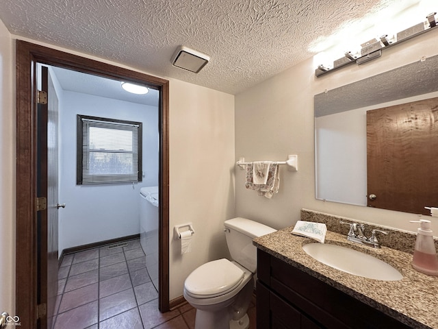 bathroom featuring baseboards, toilet, vanity, tile patterned floors, and a textured ceiling