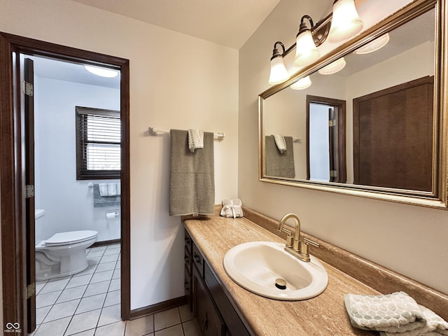 bathroom with tile patterned flooring, toilet, vanity, and baseboards