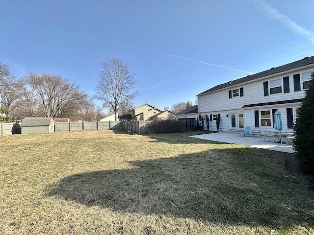 view of yard with a patio, an outbuilding, and a fenced backyard